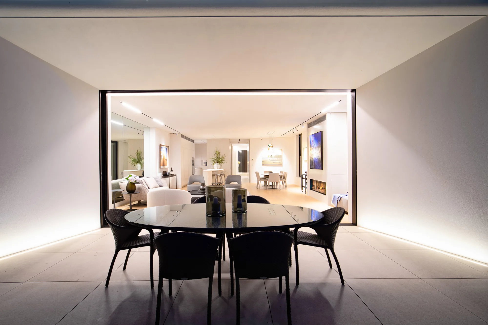 Dining space illuminated by statement lighting