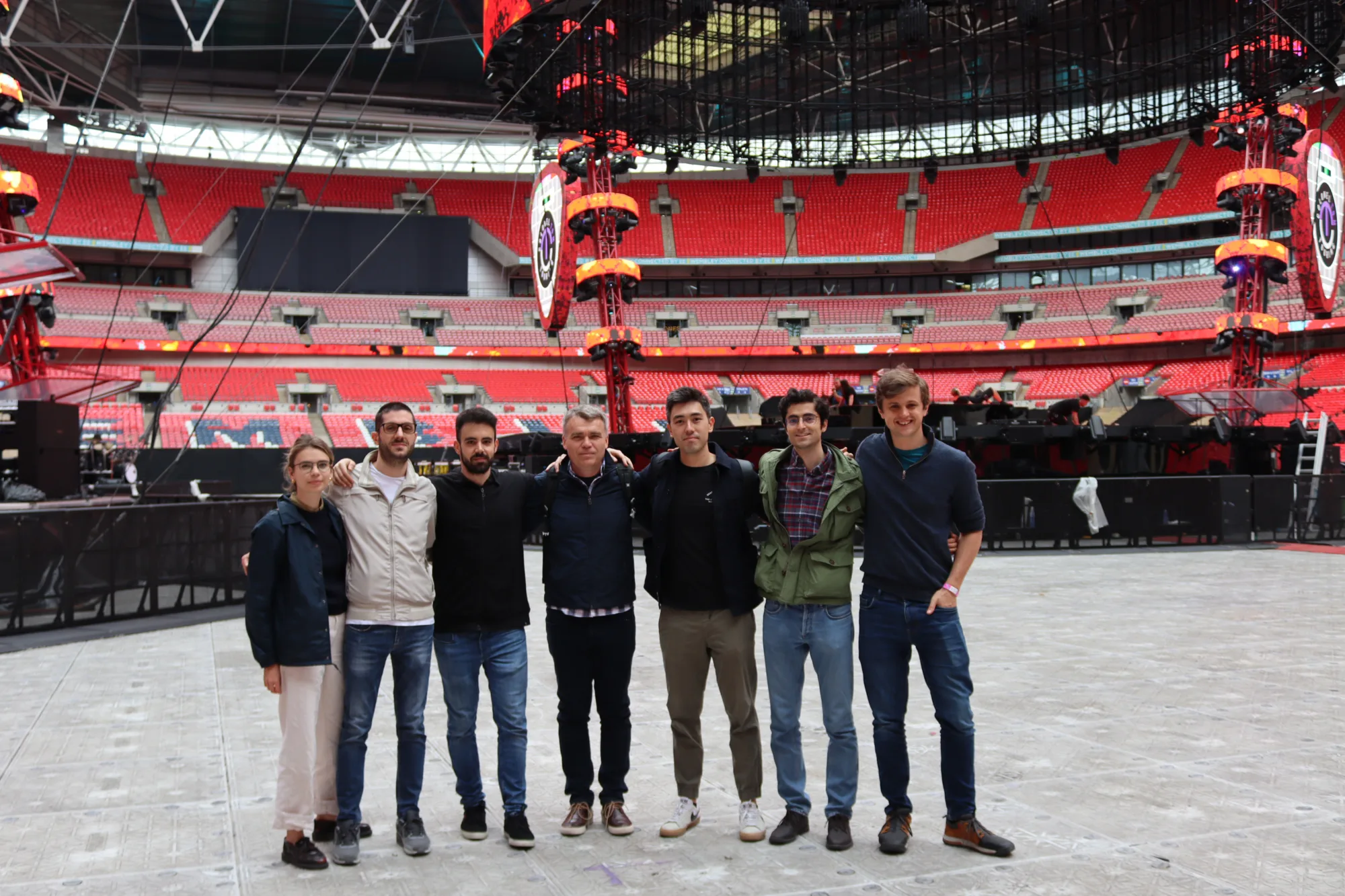 Structural team from Cundall standing in front of main stage with red seating behind them