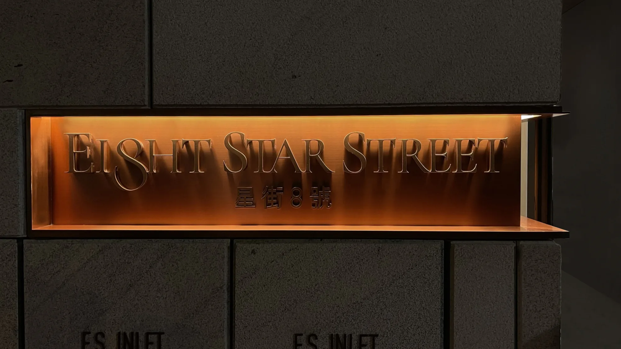 Closeup of Eight Star Street building illuminated channel letter sign.