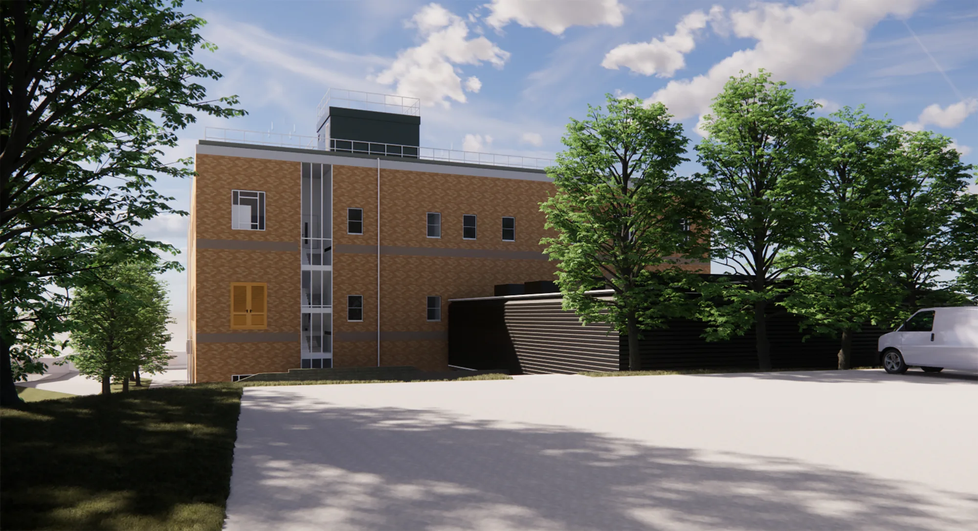 A brick building with several rectangular windows and a vertical glass panel stands beside trees and a paved open area. A white van is parked on the right, and the sky is partly cloudy.