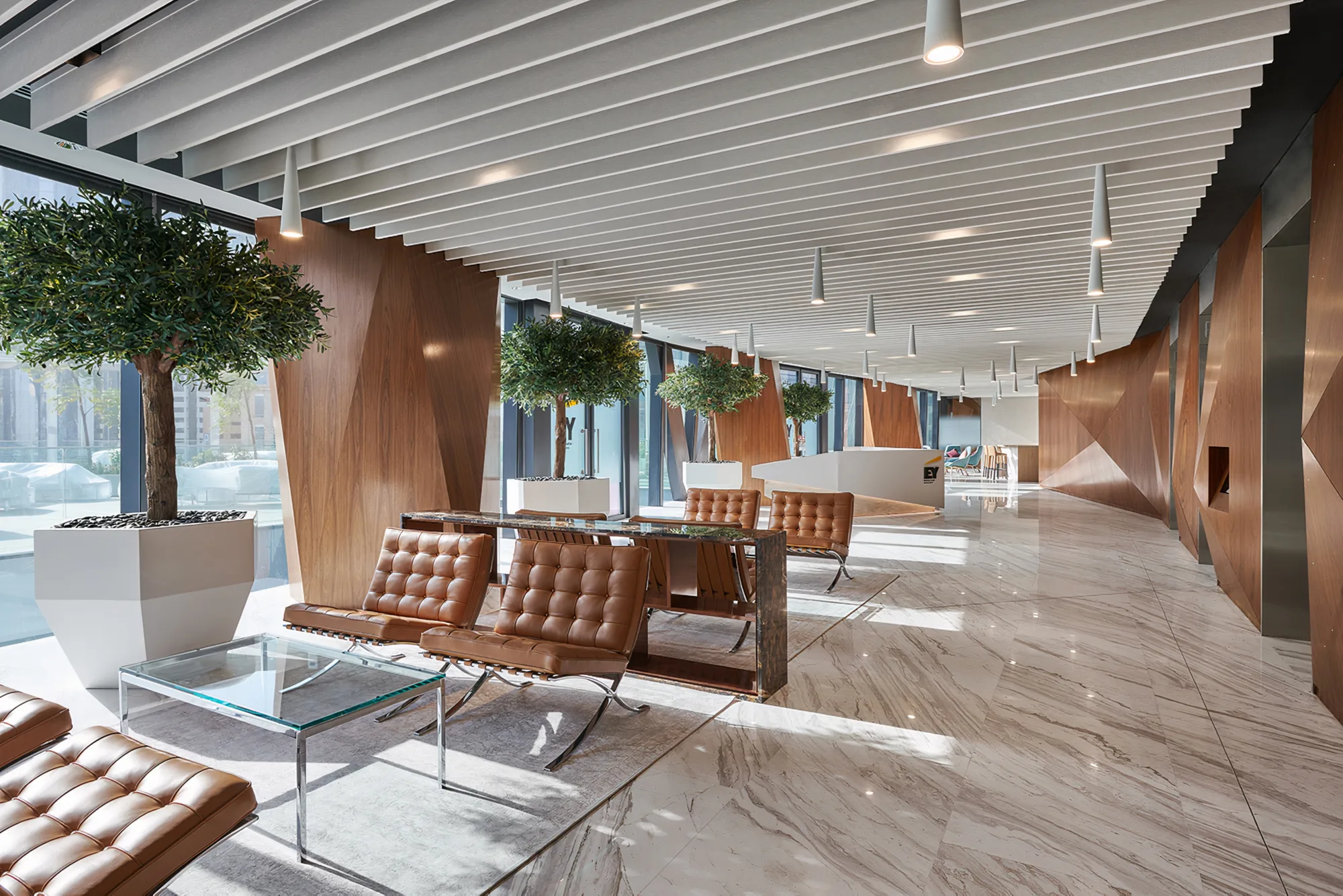 EY Dubai Office reception and waiting lounge with marble flooring and large plants