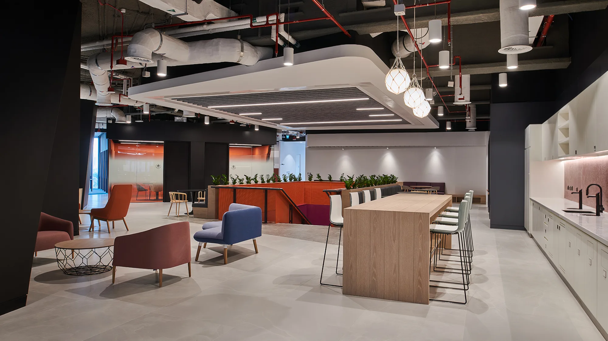 EY Dubai office upper floor recreation and pantry area with kitchen sink and tables