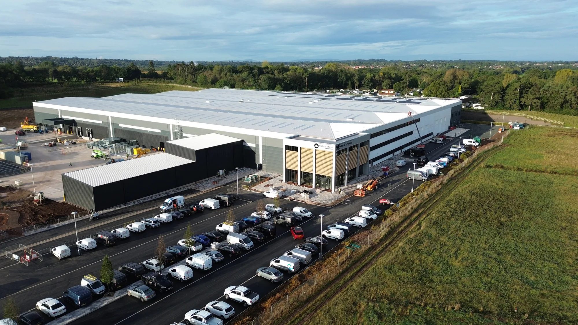A large industrial block with cars parked outside