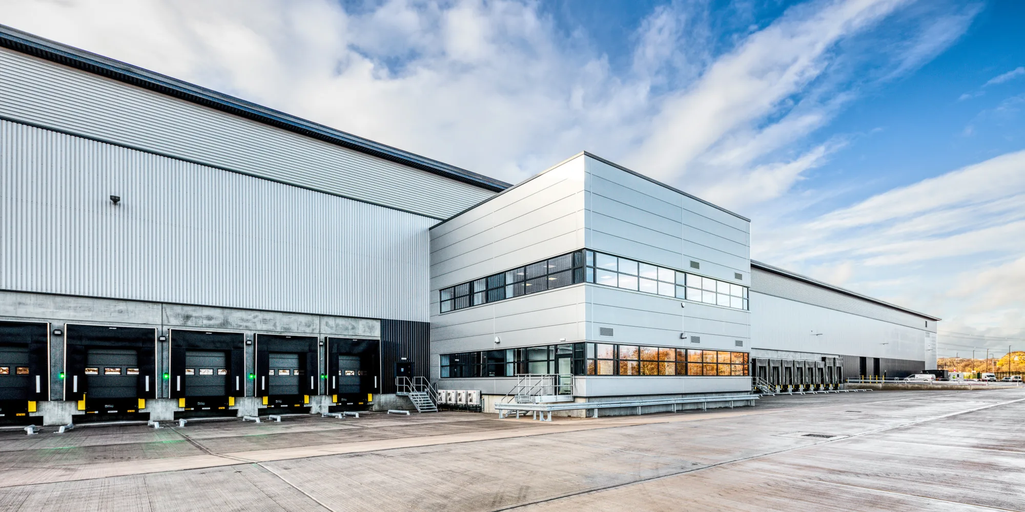 Gateway 4 a large white industrial unit against a blue, cloudy sky