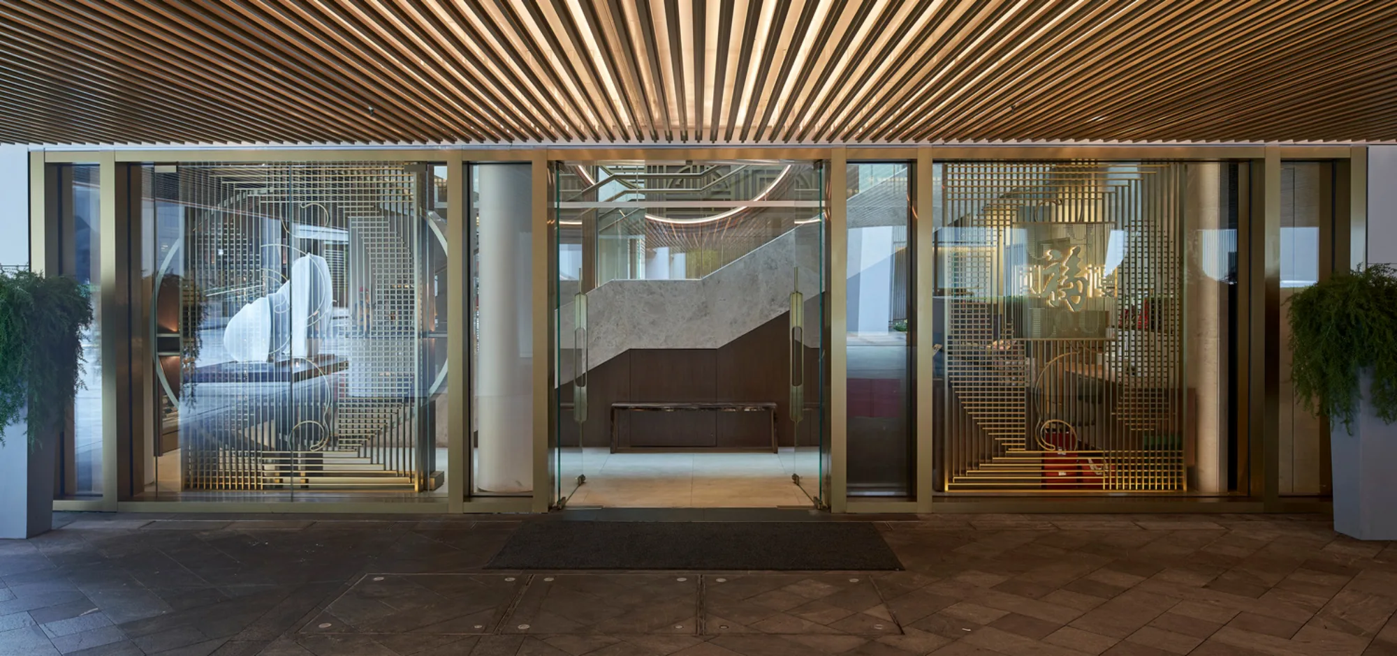 Exterior view of Guo Fu Lou’s entrance featuring staircase with lighting design