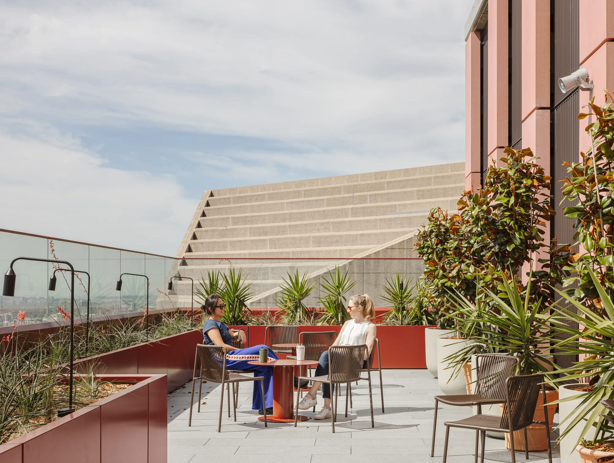 Rooftop communal surrounded by plantings.