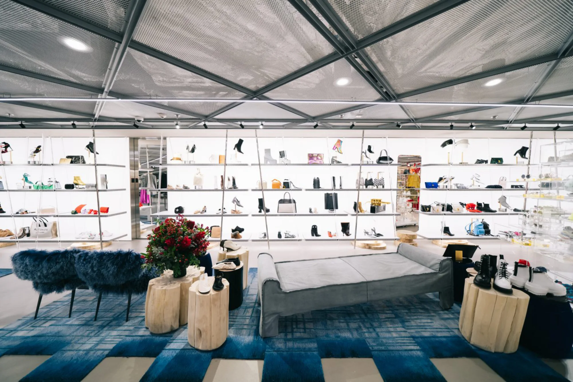 Shot of the shoe section, lighting designs can be seen in the shelves which displayed all the shoes and tailor-made downlight fixture can be seen at the metal mesh ceiling.