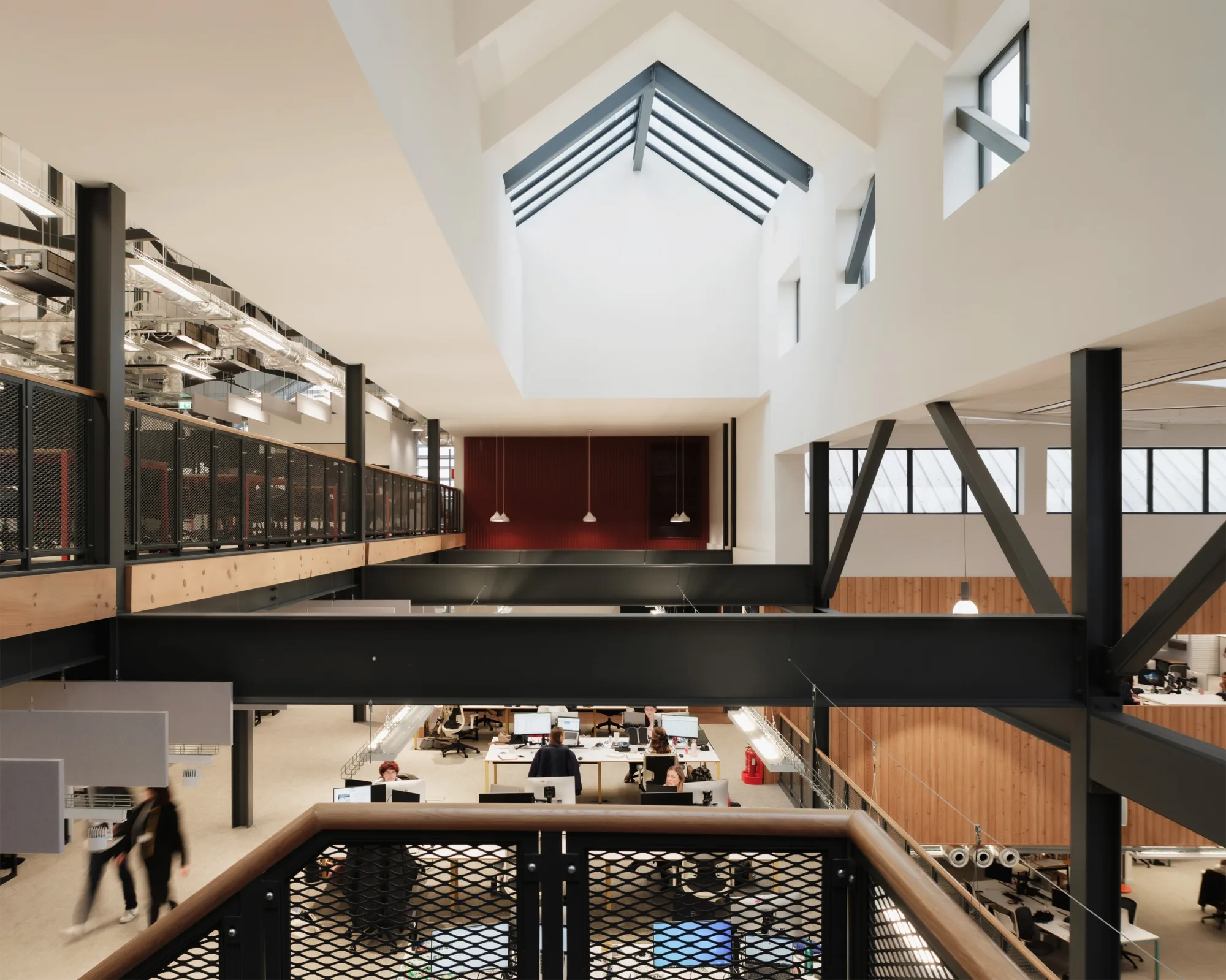 Bright multi-storey office with a tall ceiling and large roof window
