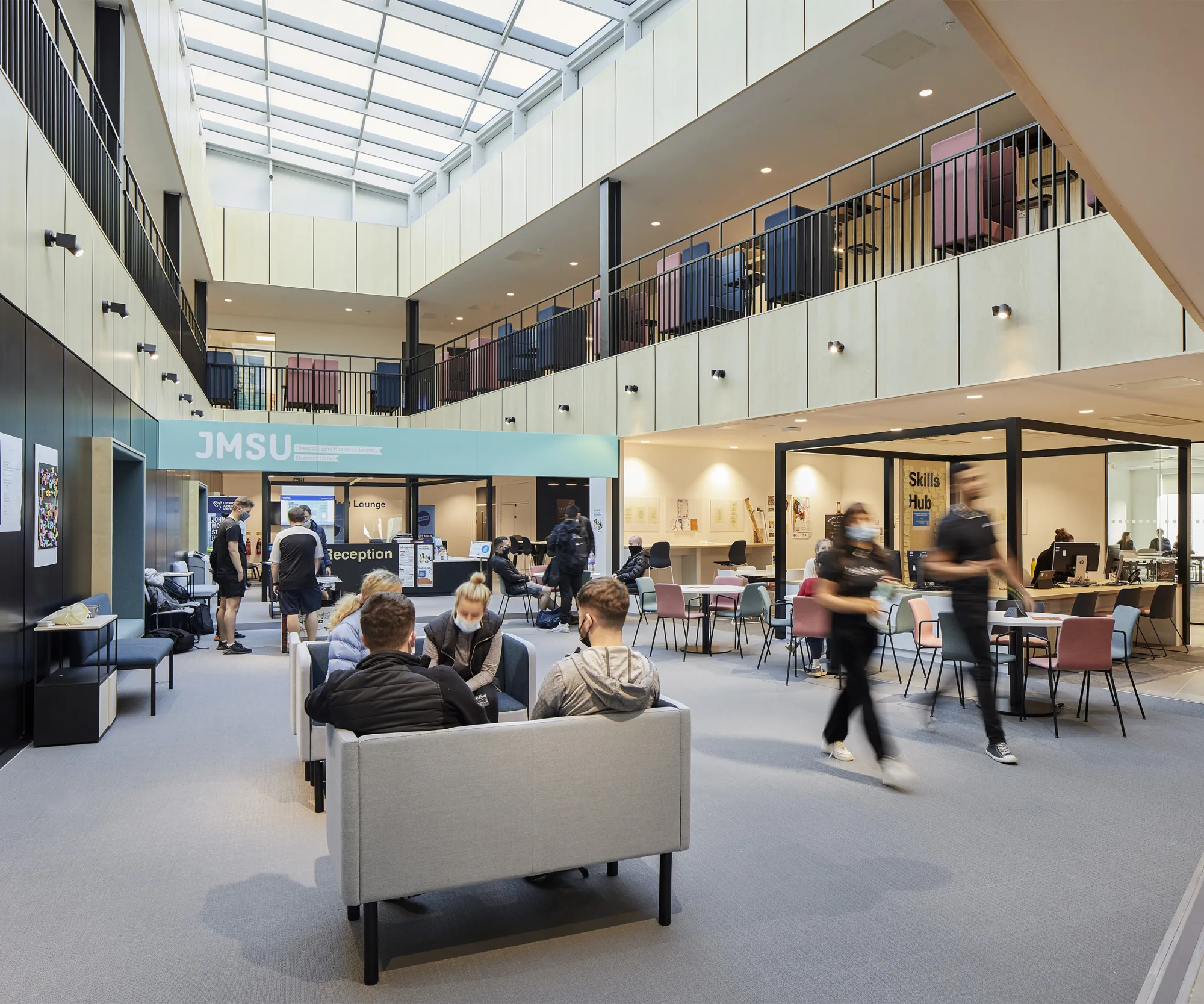 Library area showing students studying and walking