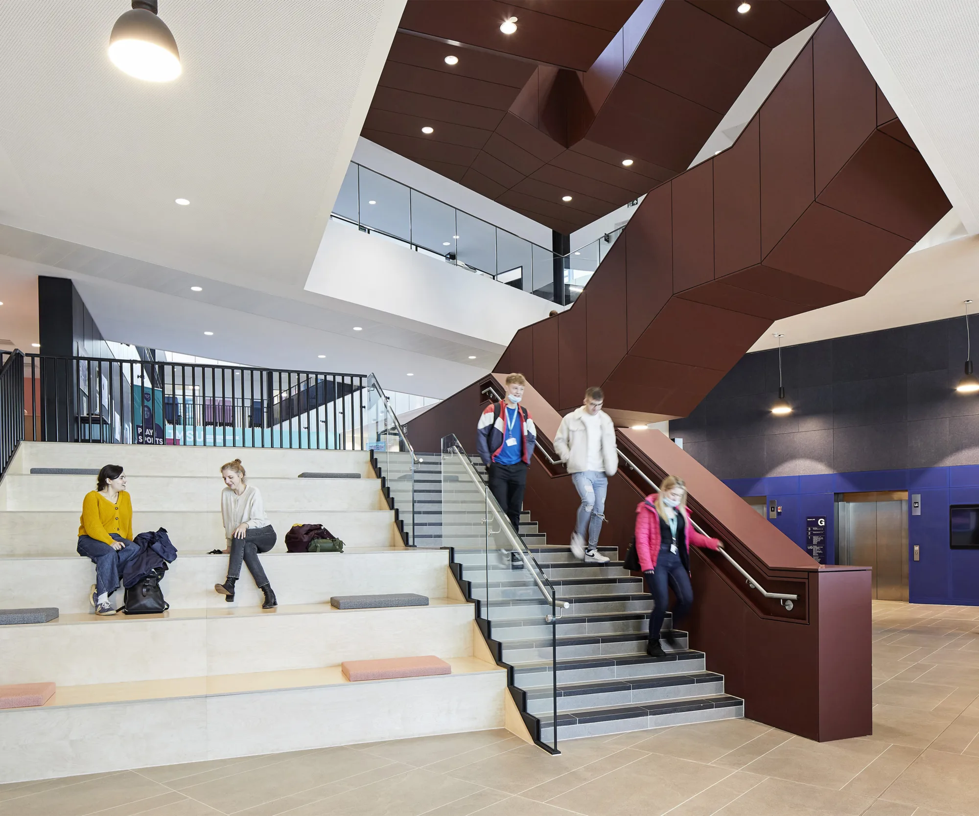 Staircase and bleachers with students sitting on them