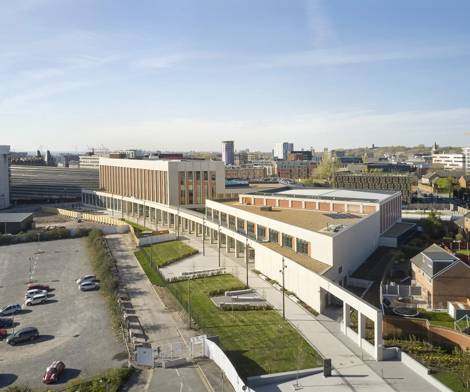 Entire campus view with blue sky and cars in car park