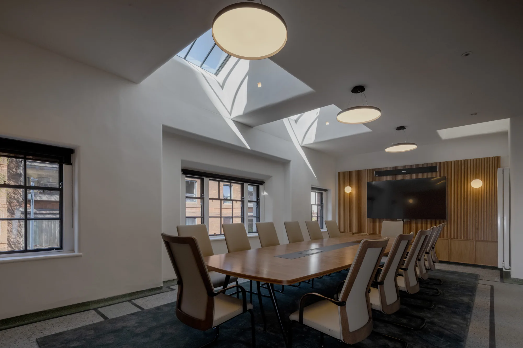 Meeting space shot with natural daylight coming in from the ceiling.