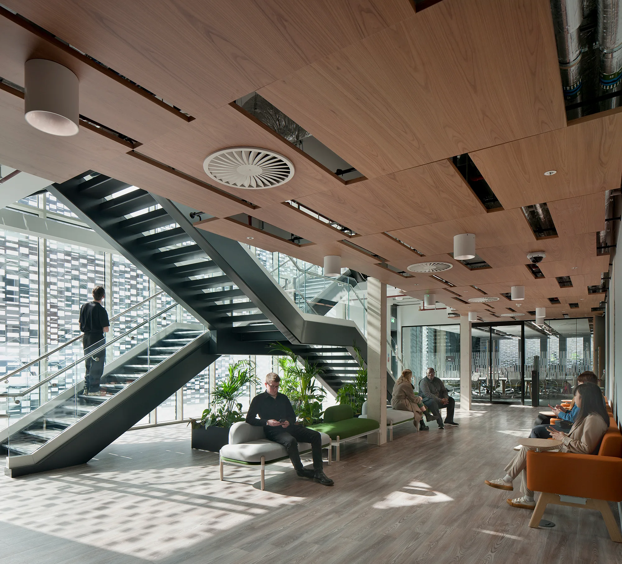 Interior of building show staircase and walkway with people flow and seating