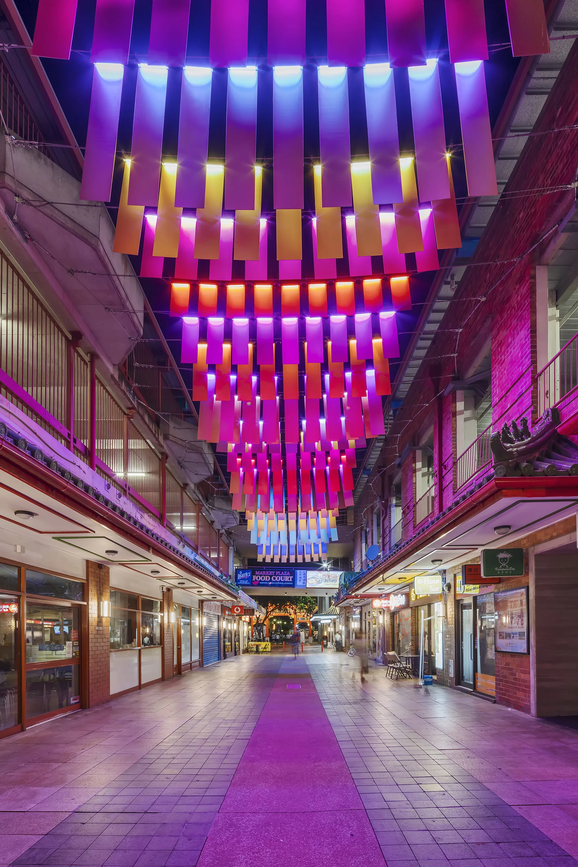 Moonta Street showing illuminated money bags hanging at night.