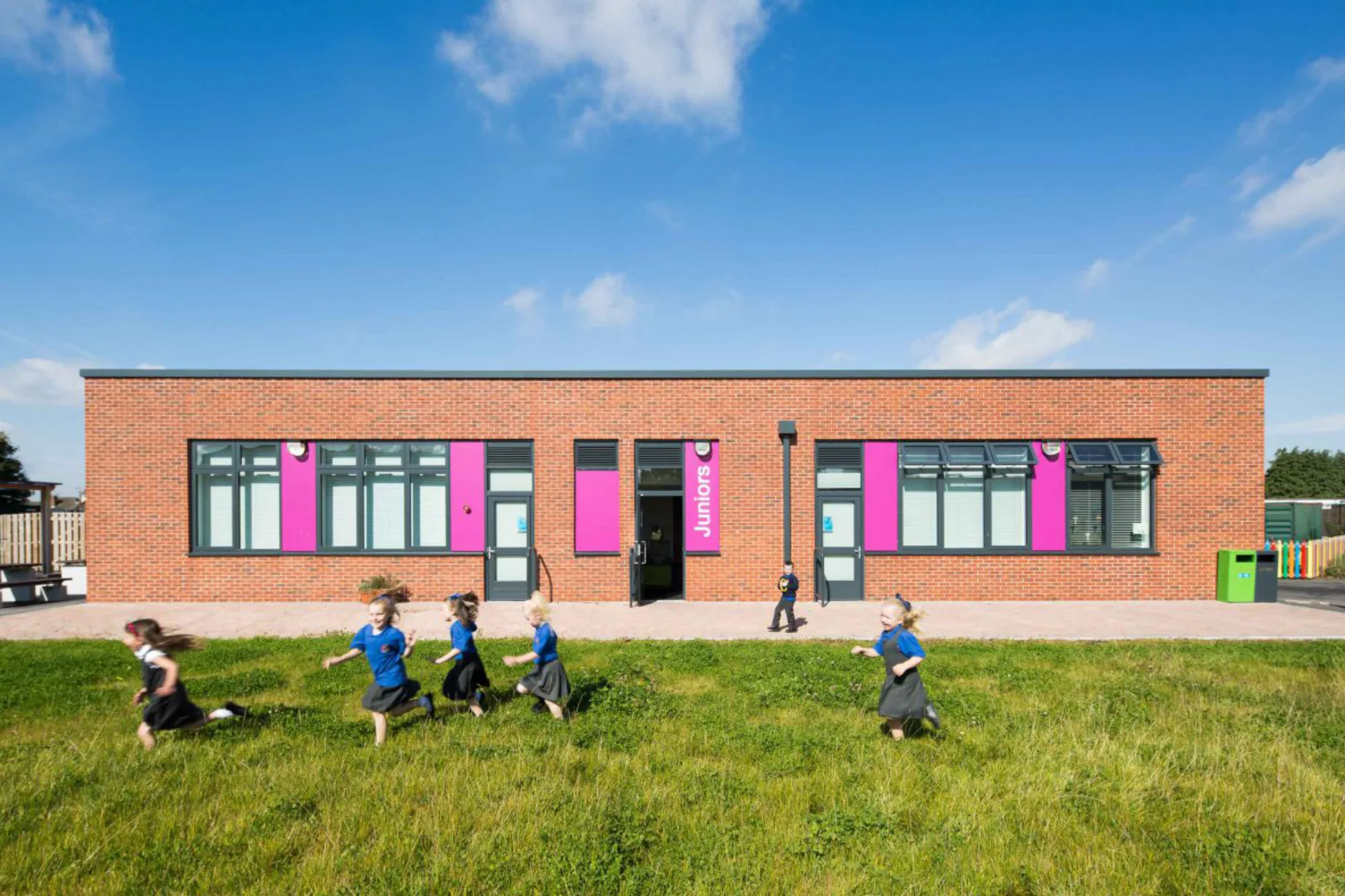Halebank school exterior against a blue sky and green grass