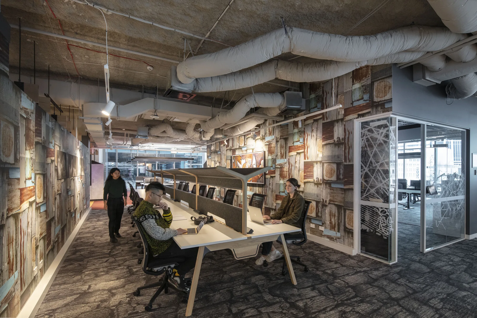 Interior study space, exposed ceilings and bespoke wallpaper on display.