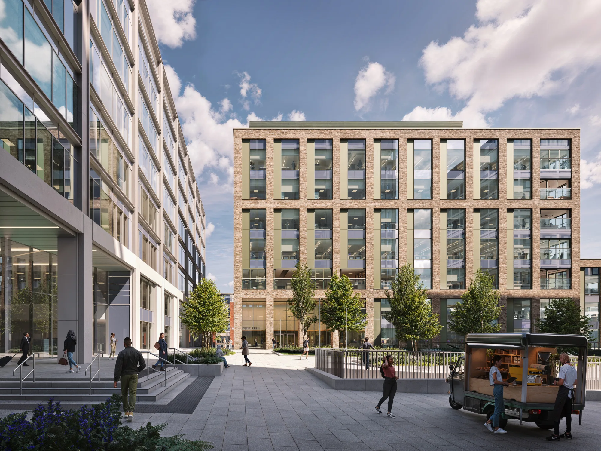 Modern urban plaza with a wide paved walkway between two multi-story office buildings. Several people are walking or standing, and a small food truck is parked on the right. Trees line the center area, and the sky is partly cloudy.