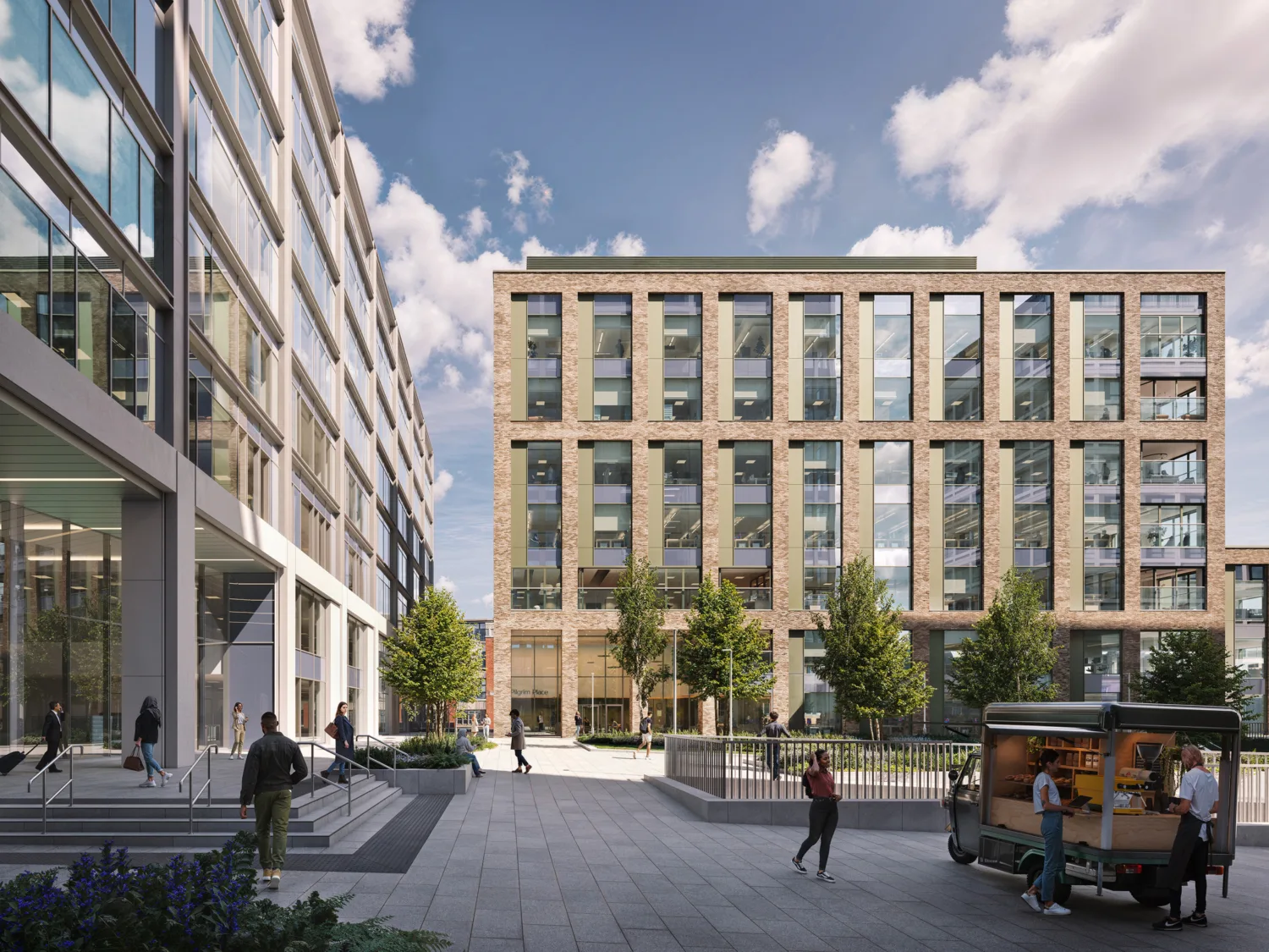 Modern urban plaza with a wide paved walkway between two multi-story office buildings. Several people are walking or standing, and a small food truck is parked on the right. Trees line the center area, and the sky is partly cloudy.