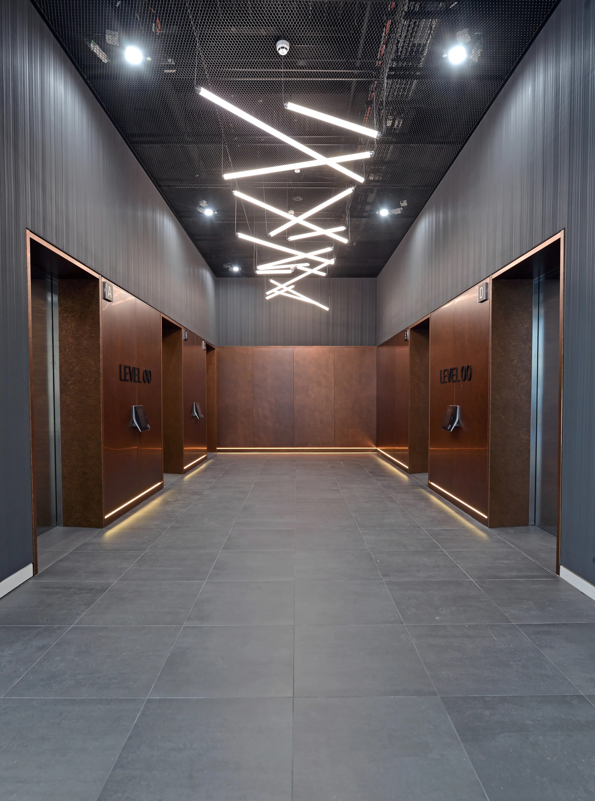 Warm, inviting interior with wooden walls and ceiling, featuring several hanging lights that create a soft, ambient glow