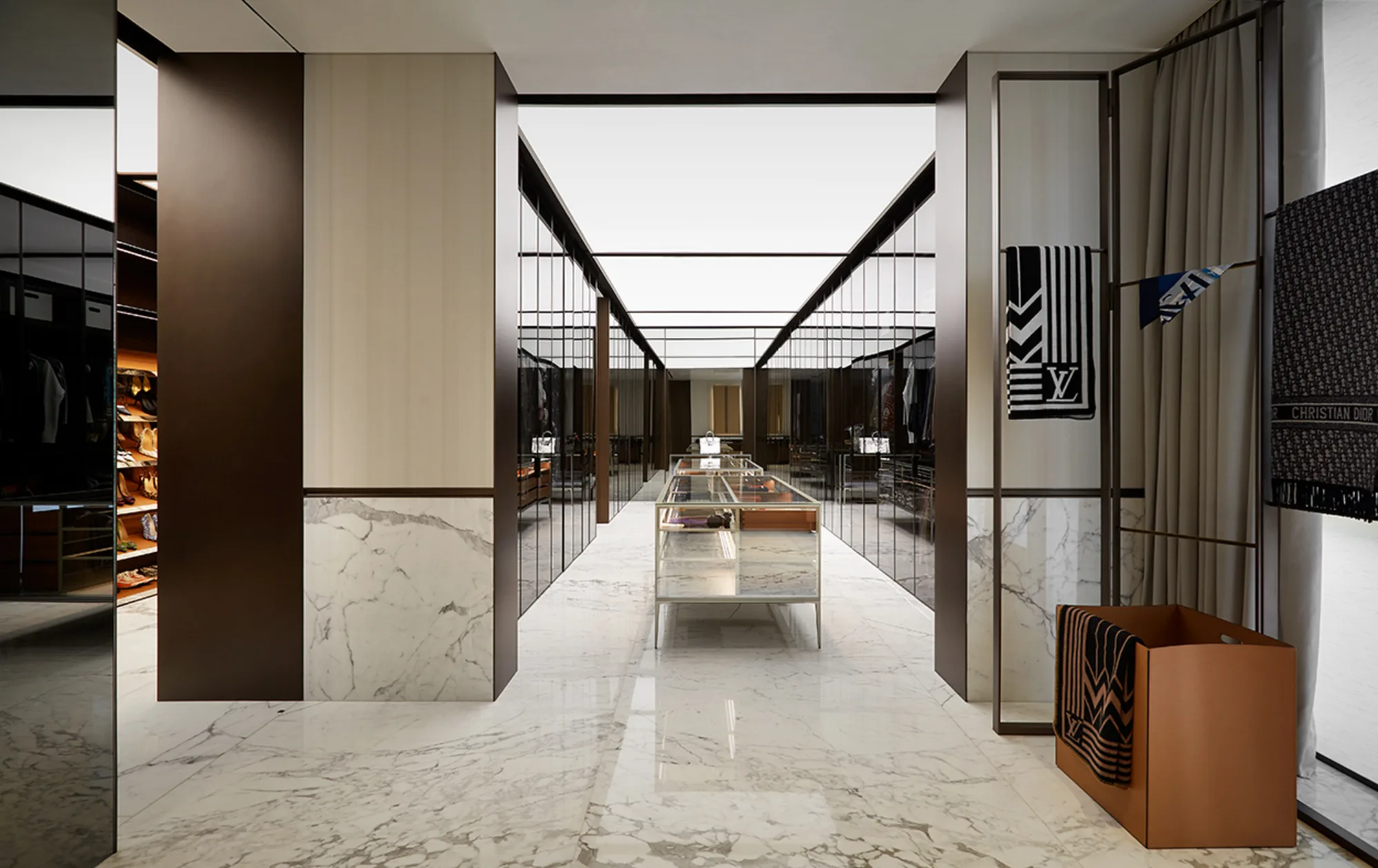 Walking wardrobe high spec with marble floors and glass doors in shades of brown and beige