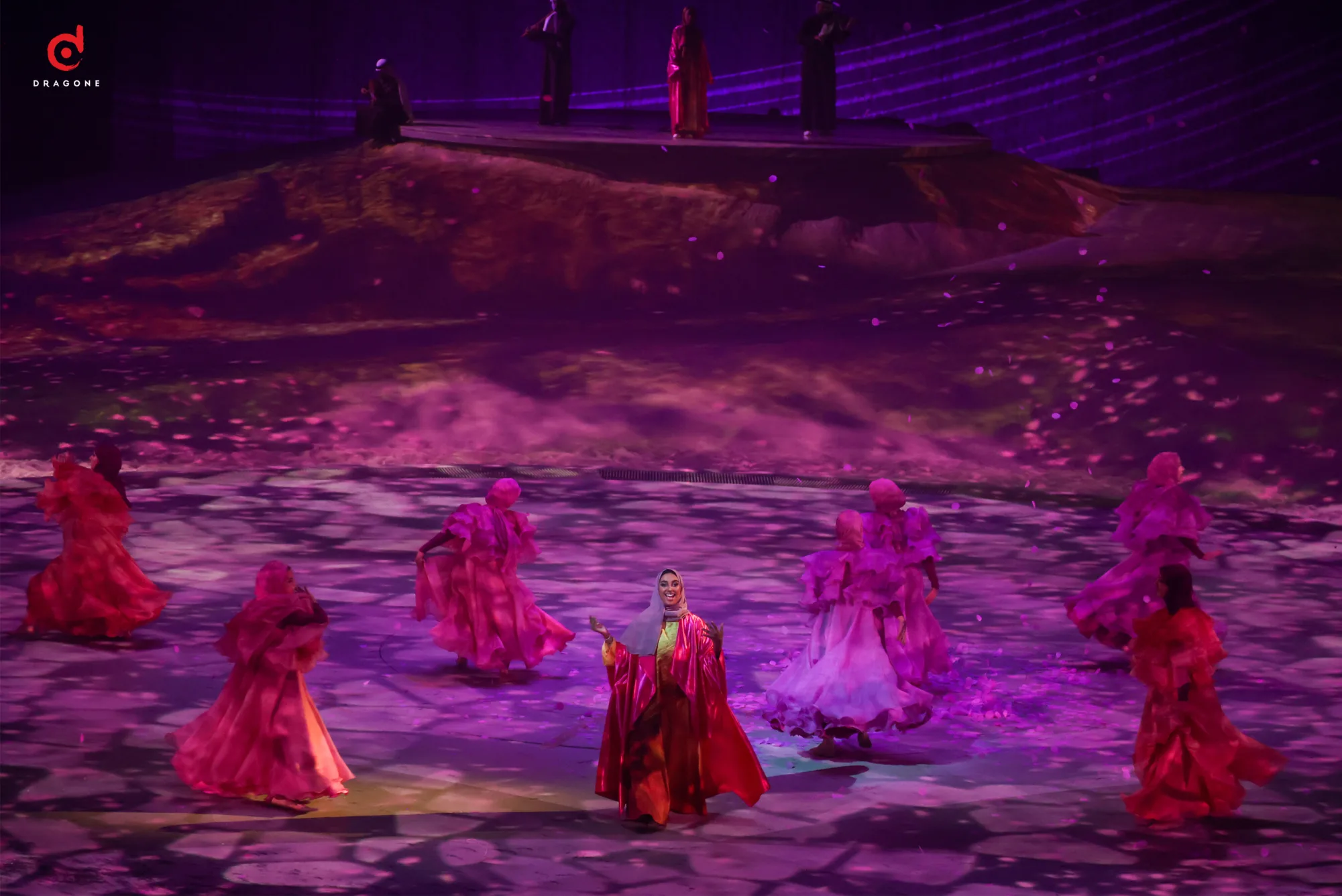 Close up of female performers under magenta lights