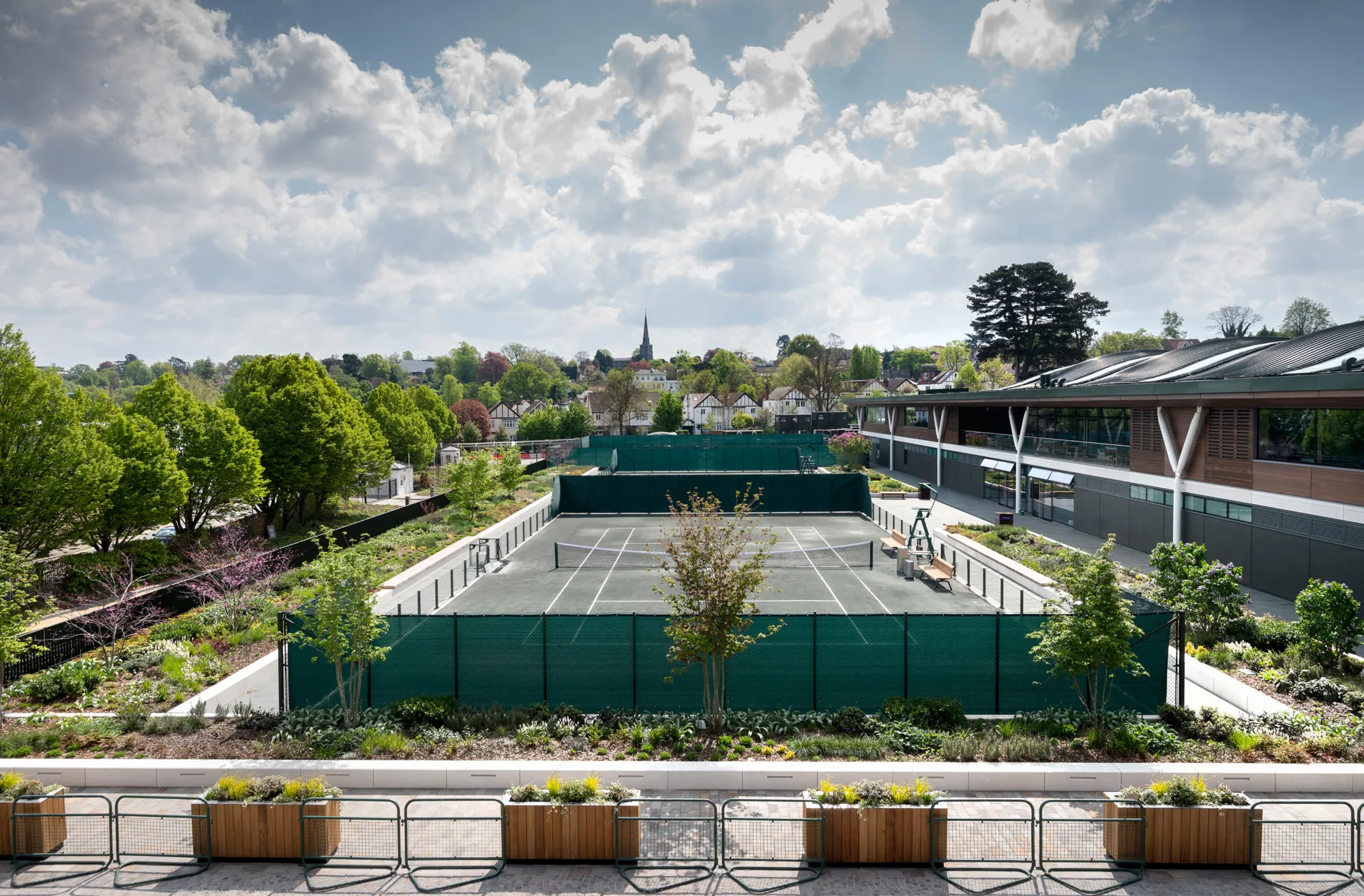 Outdoor view of the exterior tennis courts surrounded by greenery