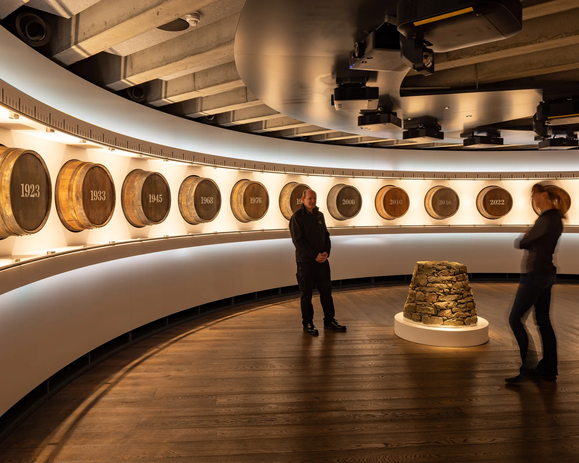 Internal view with whiskey barrels lining wall