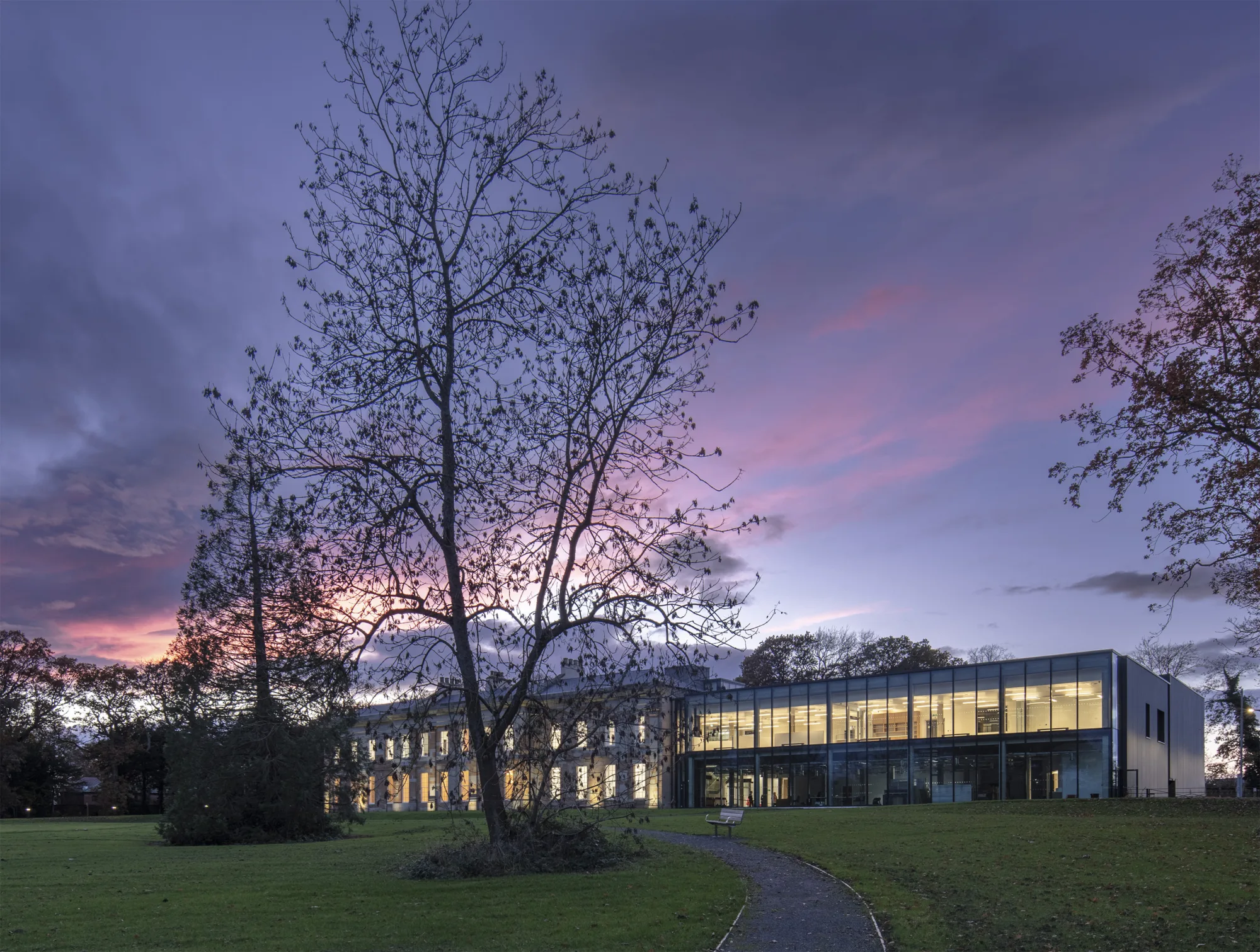 The Story building at sunset with a vibrant sky in shades of blue, purple, and pink.