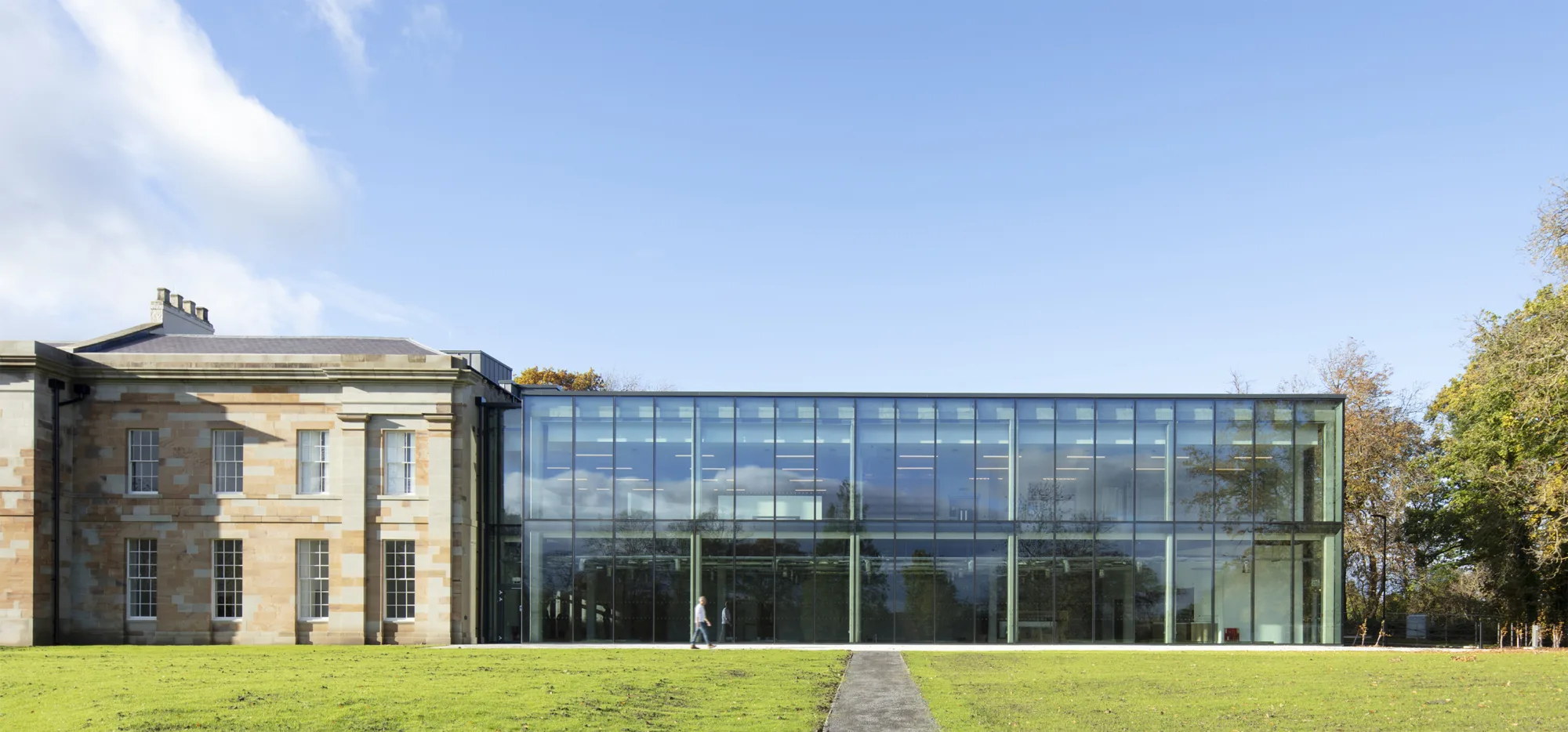 The exterior of The Story during the daytime, showing a retrofitted building with a modern glass addition on the side, blending historic architecture with contemporary design.