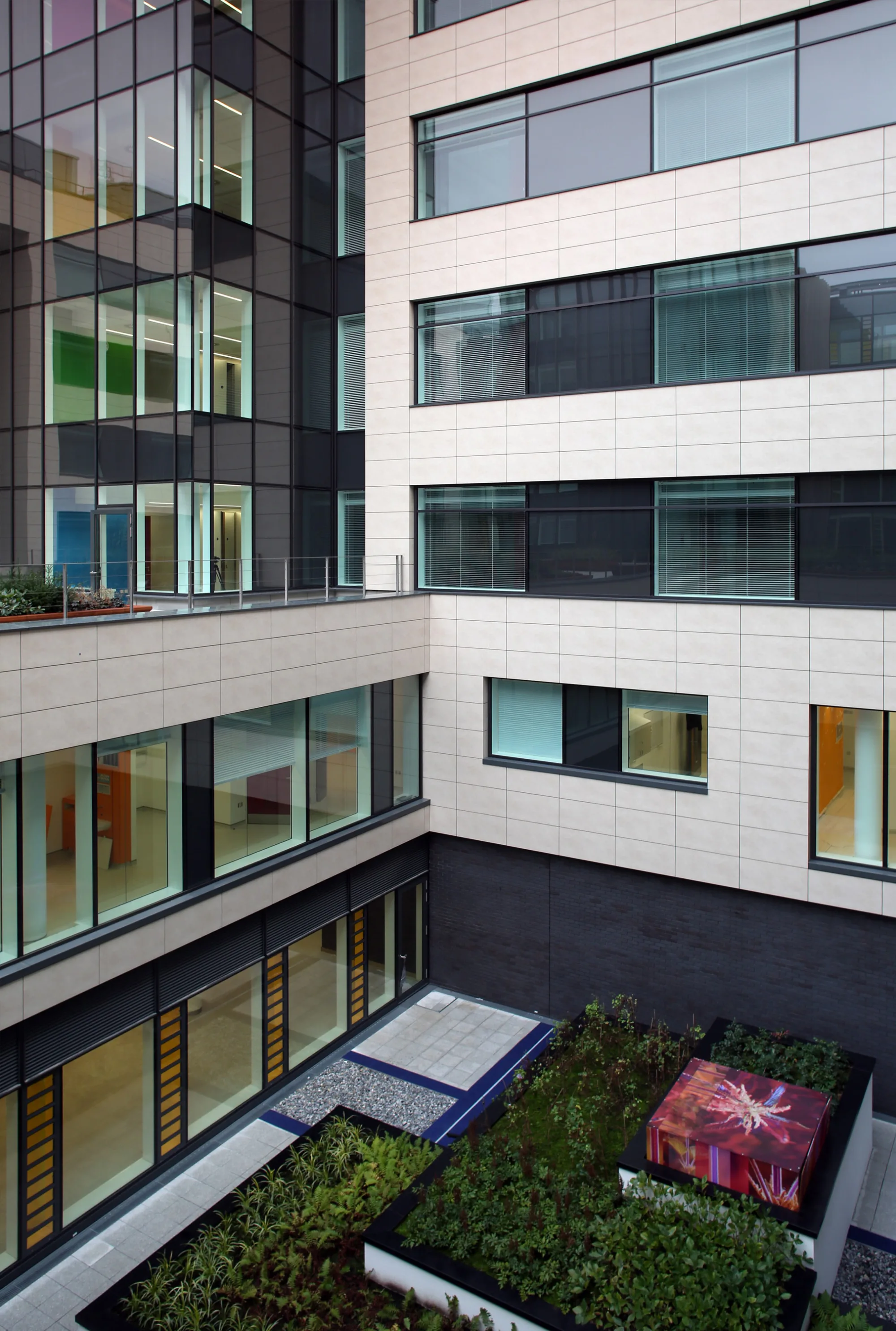 Internal courtyard with overlooking balcony and pink water feature.