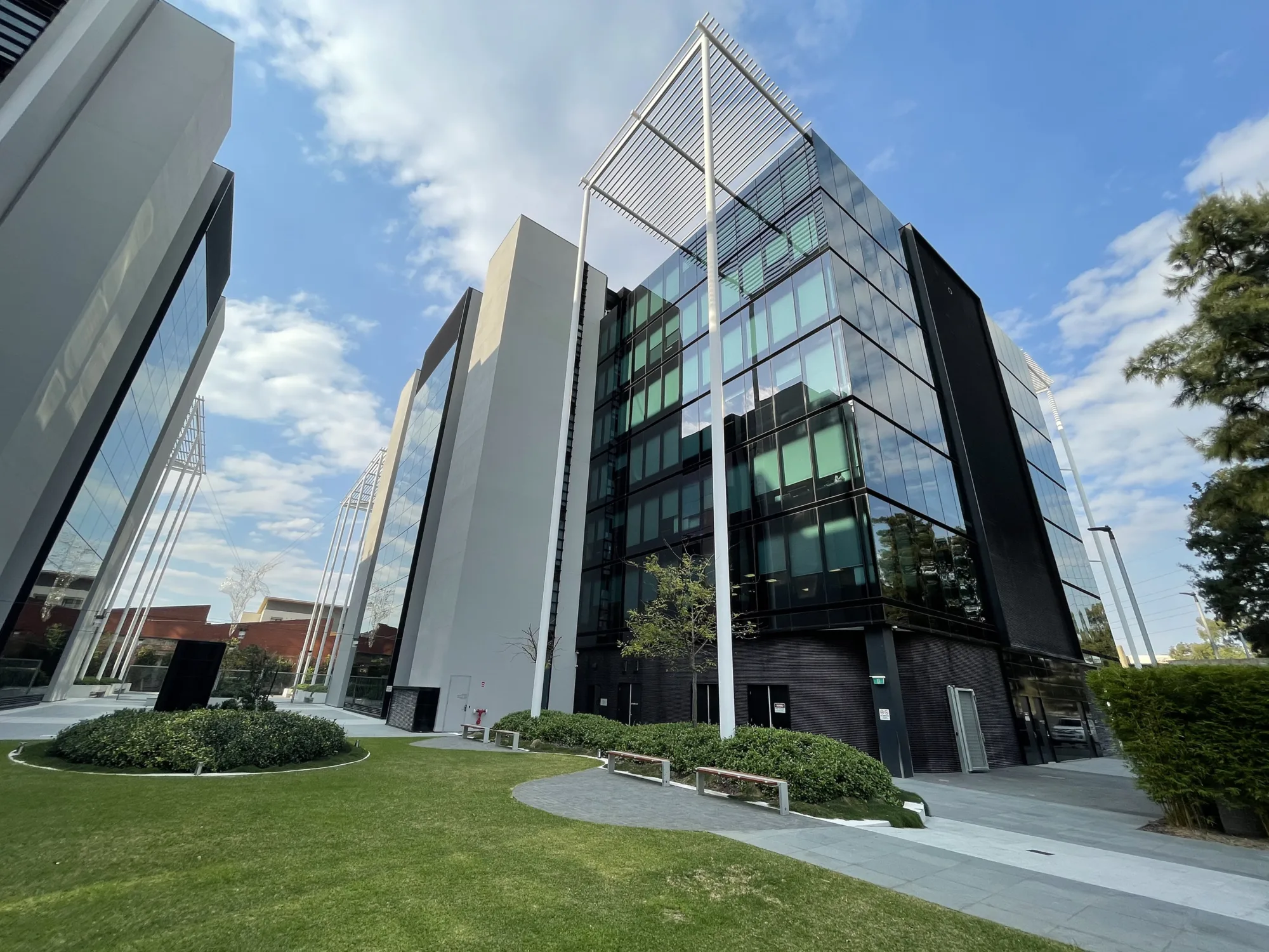 Grassy path framed by matching buildings.