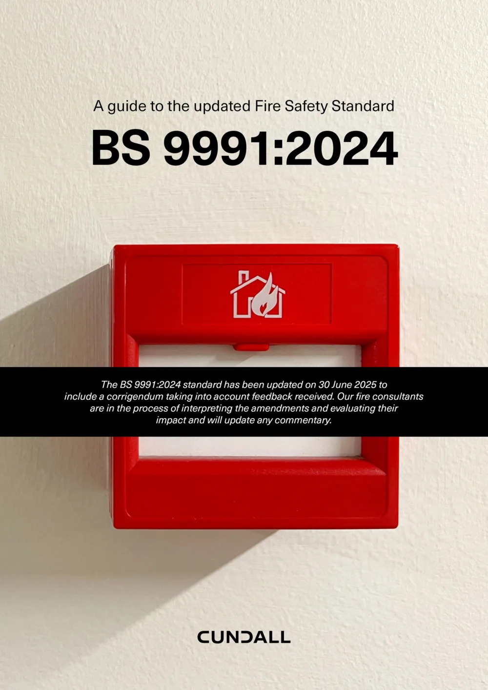 Image of a red fire alarm on a white wall with text about the updated Fire Safety Standard BS 9991:2024 and a Cundall logo at the bottom.