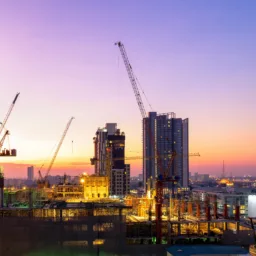 Building under construction against the purple sky