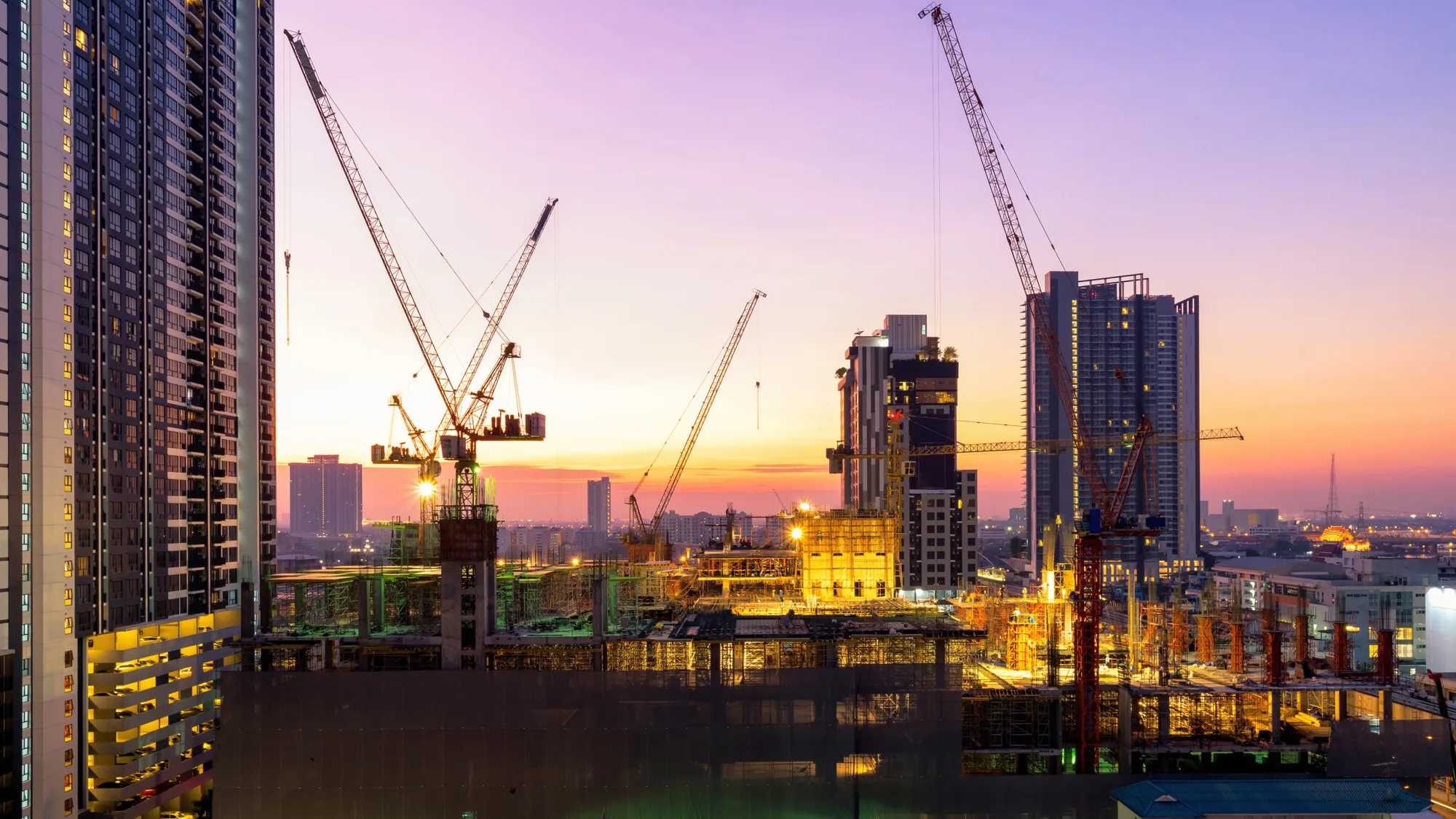 Building under construction against the purple sky
