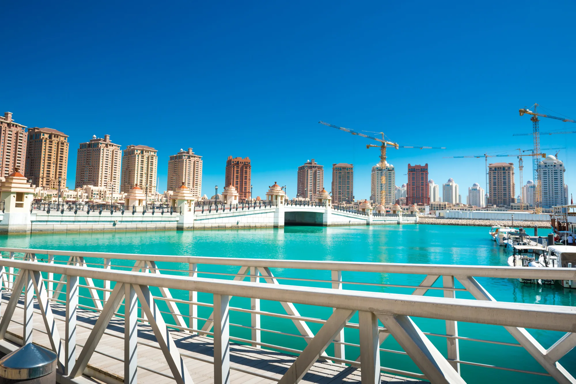 High rise buildings under construction beside a lagoon in Qatar